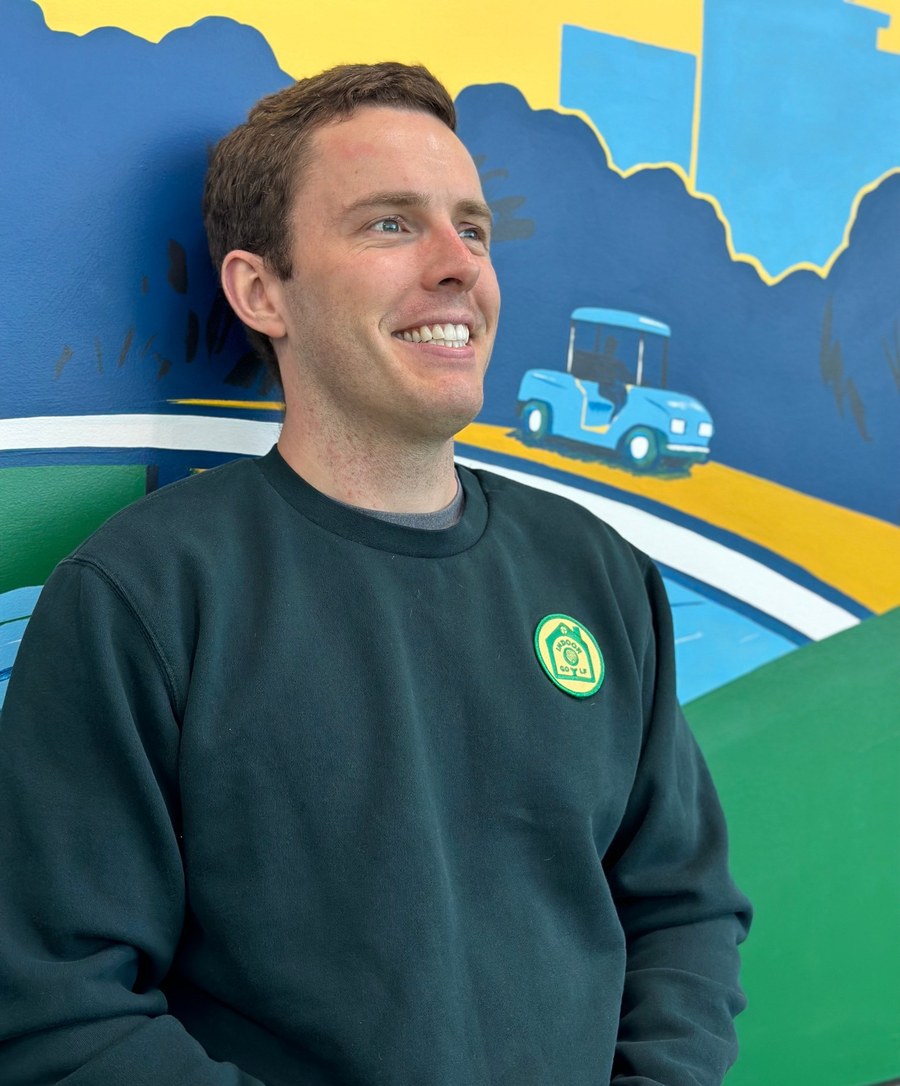 GolfSimsVA owner in an Indoor Golf RVA sweatshirt